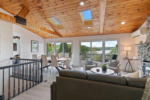 a living room with a couch and a table at The Gallagher House - Speakeasy Firepit Lakeview in Hammondsport