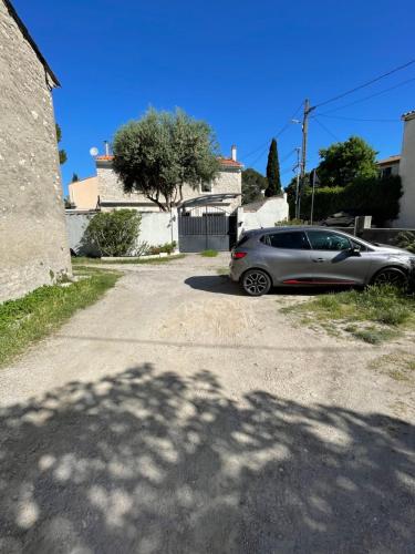 a car parked in the driveway of a house at La Coccinelle in Nîmes