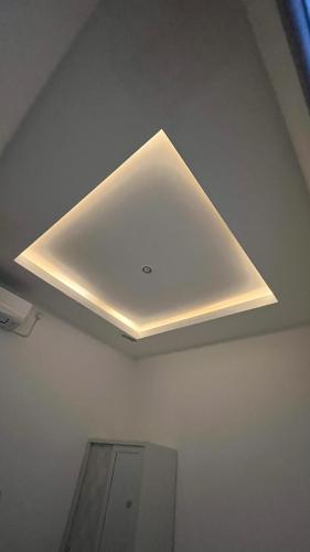 a ceiling with a light in a room at Sharia Family House in Bandasari