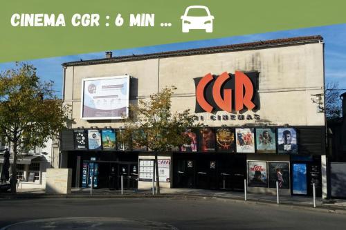 a store with a sign on the side of a building at Maison paisible proche centre avec piscine in Angoulême