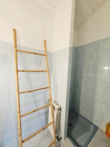 a shower with a wooden ladder in a bathroom at Maison paisible proche centre avec piscine in Angoulême