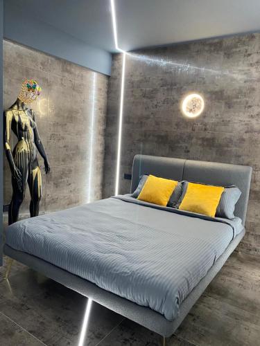 a bedroom with a bed with a robot on the wall at Luna Apartments B in Suceava