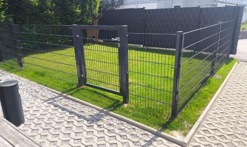 a black fence with grass behind it at ChalEna in Hochpillberg