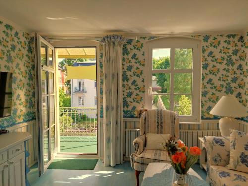a living room with a chair and a window at Villa Lindenhof in Bad Elster
