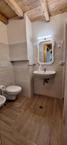 a bathroom with a sink and a toilet and a mirror at La casa del Maestro - Gallipoli - centro storico in Gallipoli