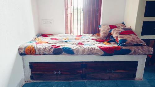 a unmade bed in a room with a window at Vyugen Villa #01 in Kāraikkudi