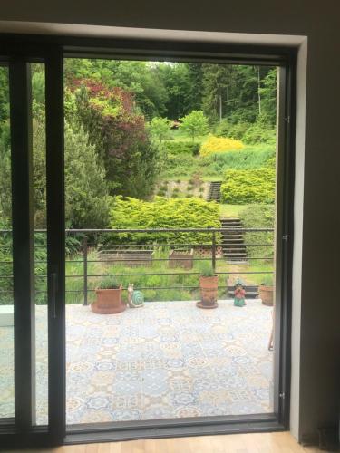 a window view of a patio with potted plants at Apartament z kotem in Bielsko-Biala