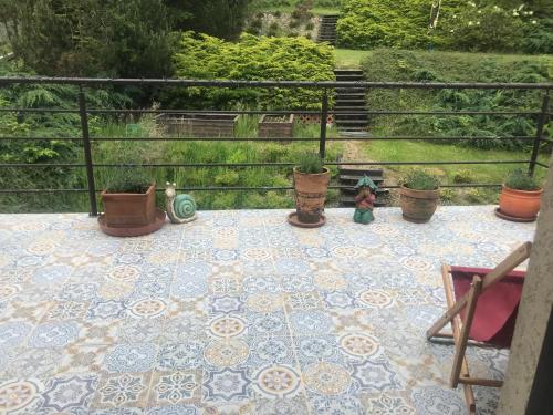 a patio with potted plants on a tiled floor at Apartament z kotem in Bielsko-Biala
