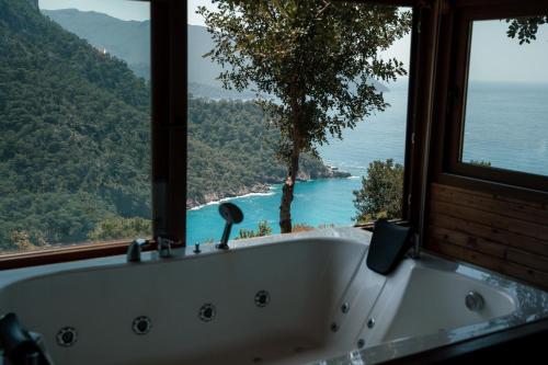 a bath tub with a view of the ocean at Olive Garden Kabak in Faralya