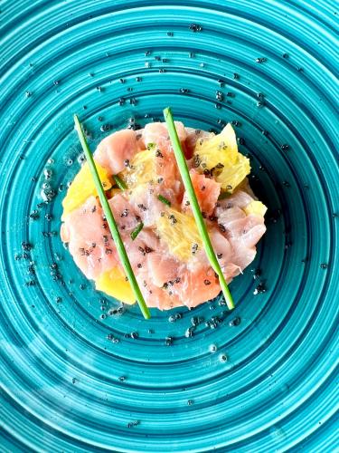 a plate with a piece of sushi with chopsticks on it at Rock and Sea Resort in Watamu