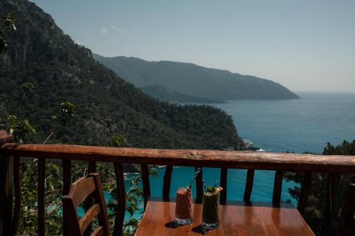 a balcony with a view of the ocean and mountains at Olive Garden Kabak in Faralya