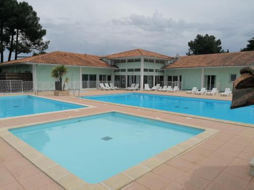 une grande piscine devant un immeuble dans l'établissement Duplex résidence la cascade, à Dolus-d'Oléron