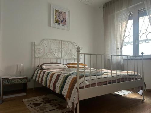 a bedroom with a bed and a window at La casina di Ale in Turin