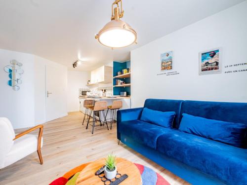 un salon avec un canapé bleu et une table dans l'établissement OIQIA • Advena • Montgolfier, à Annonay