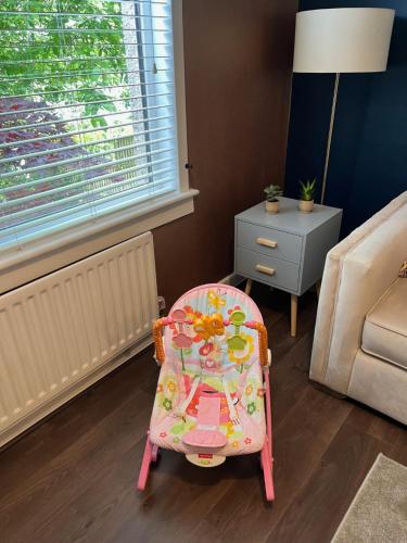 a childs chair and a table in a living room at 3 bedroom house in Kirkaldy, Fife in Fife