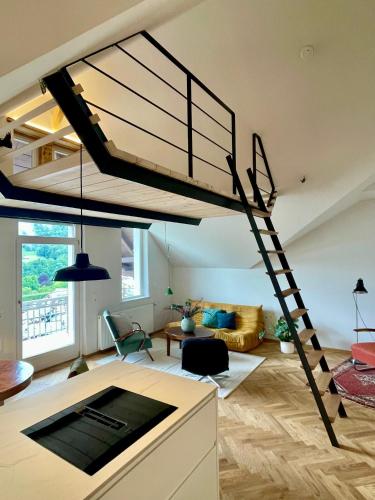 a living room with a spiral staircase in a loft at Loft über Berchtesgaden in Berchtesgaden