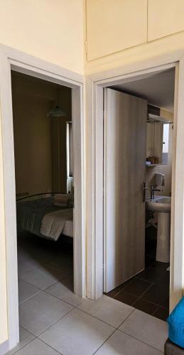 a bedroom with a bed and a sink in a room at Rooftop flat in Chalkida