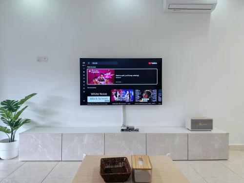a flat screen tv on a white wall at 10Pax BM大山脚 Alma Single storey Semi-D 5-minute To Aeon Mall in Bukit Mertajam
