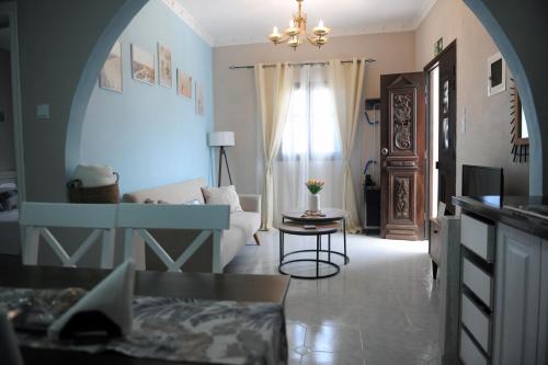 a living room with a couch and a table at Oxo Kamara Apartment in Karpathos Town