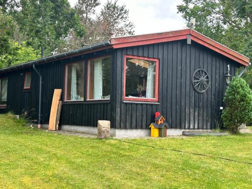 a black house with a window and a toy at Pax House in Storvorde