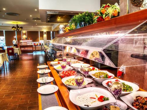 a buffet line with plates of food in a restaurant at Porto Matrouh Majestic in Marsa Matruh