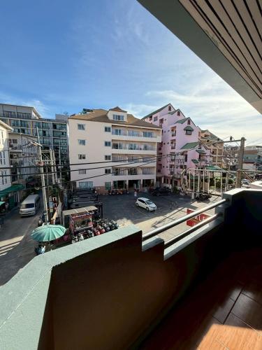 a view from a balcony of a city with buildings at Malee Guesthouse & Restaurant in Pattaya