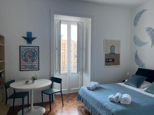 a bedroom with a bed and a table and a window at Casa Boccardi in Taranto