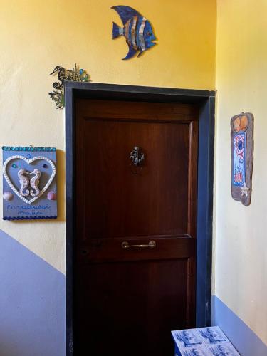 a door in a room with a fish on the wall at I cavallucci marini in Lerici