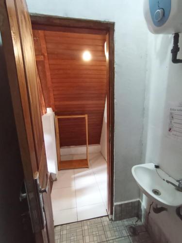 a small bathroom with a toilet and a sink at Aikoli Kang Resort in Miafeng