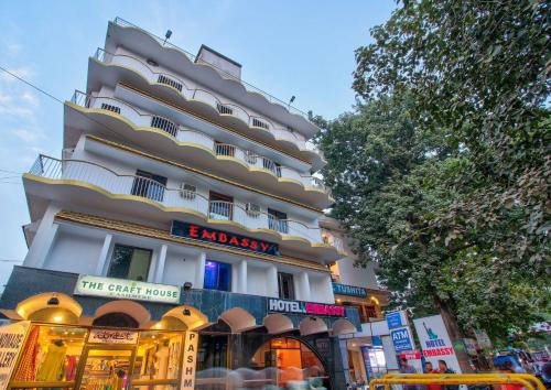 a tall building with a store in front of it at Hotel O Embassy in Bodh Gaya