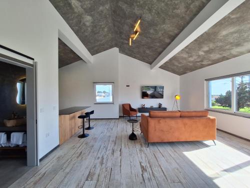 a living room with a couch and a table at Central Lava 27 Apartment in Madalena