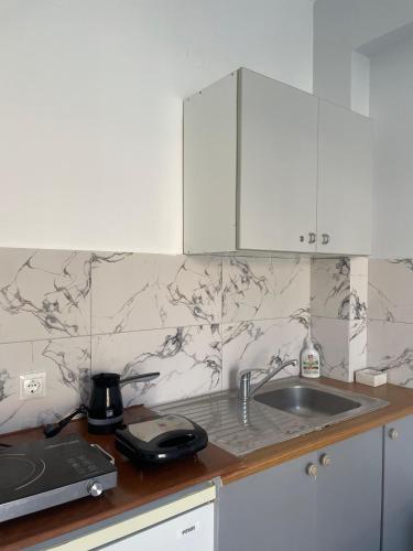 a kitchen with a sink and a counter top at Marina Apartaments in Himare