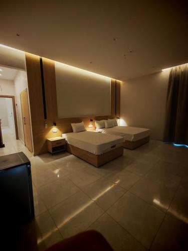 a hotel room with two beds and two lamps at cleopatralife in Cairo