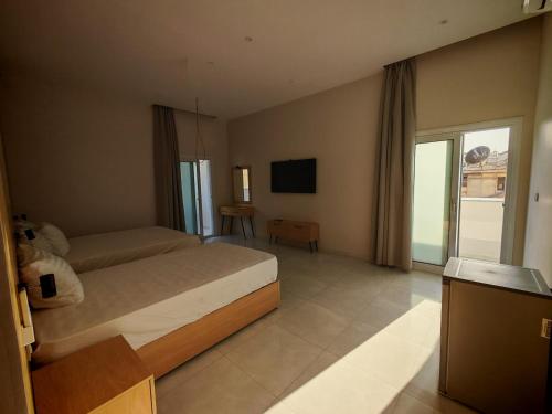 a hotel room with a bed and a television at cleopatralife in Cairo
