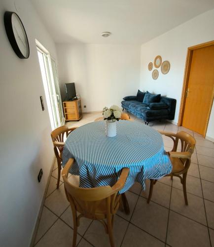 a living room with a table and chairs and a couch at Apartmani Suton in Primošten