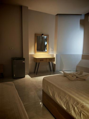 a bedroom with a bed and a desk with a mirror at cleopatralife in Cairo