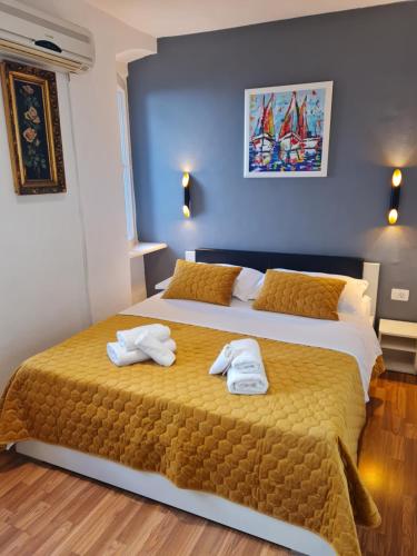 a bedroom with a bed with towels on it at INCHY ACCOMMODATION - in the center of Diocletian's Palace in Split