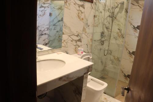 a bathroom with a sink and a shower at Gatetrees resort in Jaffna