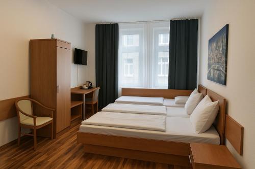 a hotel room with two beds and a window at Centro Hotel Oberhausen in Oberhausen