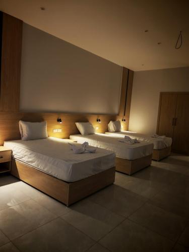 two beds in a hotel room with lights at cleopatralife in Cairo