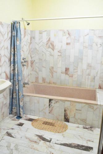 a bathroom with a tub and a sink at Hotel Topacio in San Juan de los Lagos