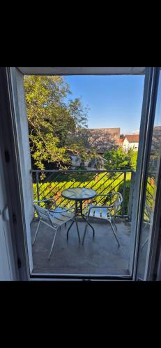 a view of a table and chairs from a window at Riedisheim, F3Confort & tranquillité residence privé & parking privé in Riedisheim