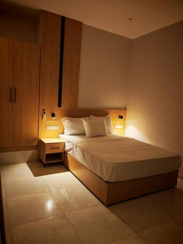 a bedroom with a bed with two lights on it at cleopatralife in Cairo