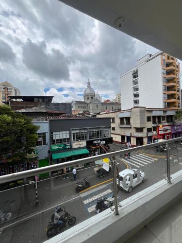 a view of a city with motorcycles on a street at Hotel Éxito Pereira Center in Pereira