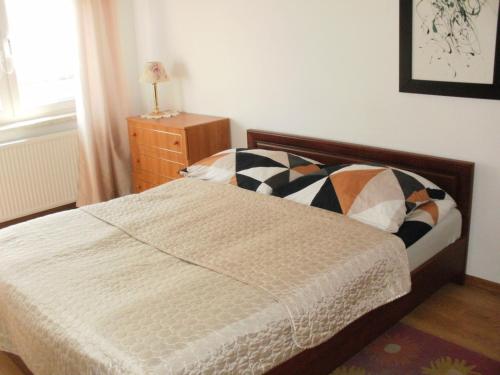 a bedroom with a bed and a dresser and a window at Pokoje w Pucku u Ewy in Puck