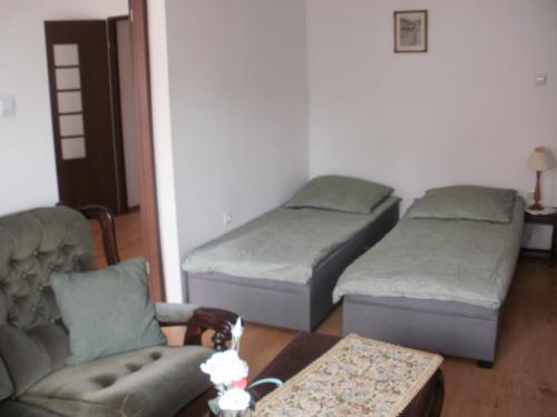 a living room with two beds and a couch at Pokoje w Pucku u Ewy in Puck