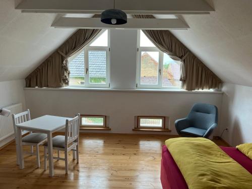 a bedroom with a table and two chairs and a bed at Na Švestkové trati in Libčeves
