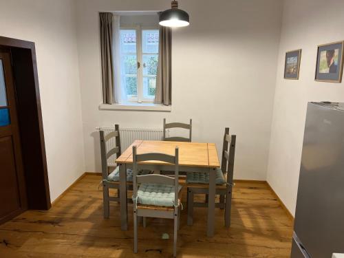 a table and chairs in a room with a window at Na Švestkové trati in Libčeves