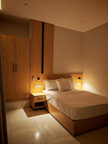 a bedroom with a bed and a cabinet and lights at cleopatralife in Cairo