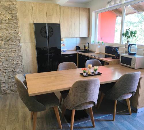 a kitchen with a wooden table and chairs at Apartment Cedar Zagreb Airport - Velika Gorica in Ščitarjevo
